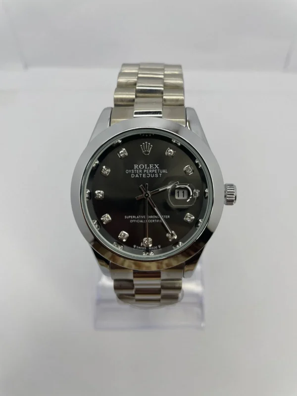 Rolex Datejust watch with black dial, diamond hour markers.