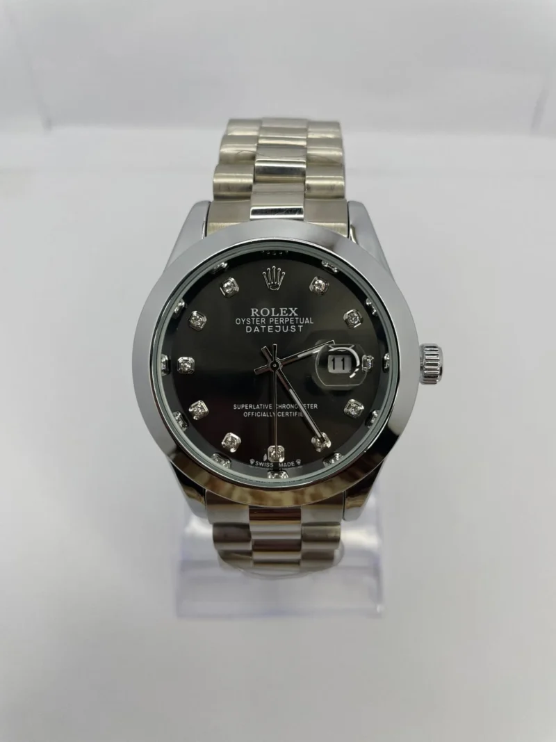Rolex Datejust watch with black dial, diamond hour markers.